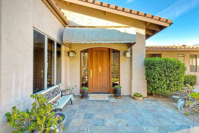 15615 Pauma Valley Dr, Pauma Valley, CA 92061 - doorway to property featuring stucco siding and a patio area
