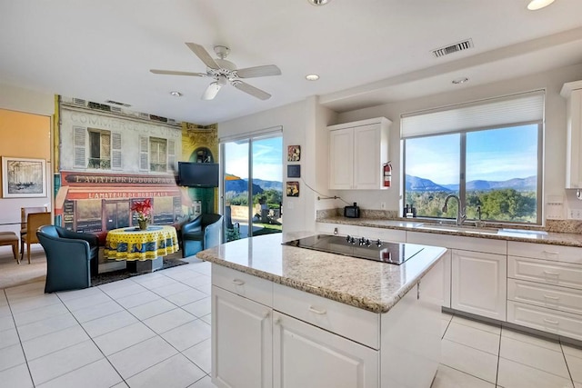 15615 Pauma Valley Dr, Pauma Valley, CA 92061 - kitchen with black electric stovetop, light tile patterned floors, a center island, ceiling fan, and recessed lighting