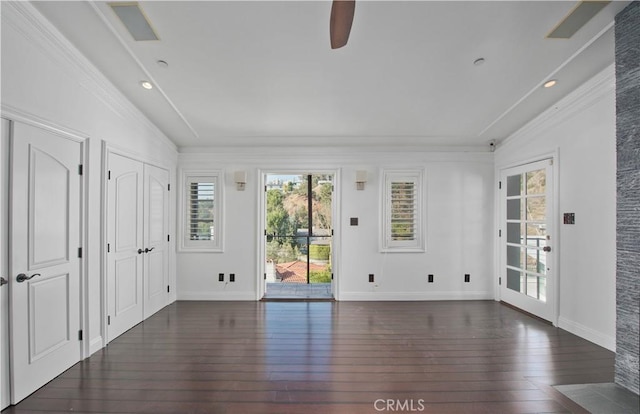 empty room featuring dark wood-type flooring and ornamental molding