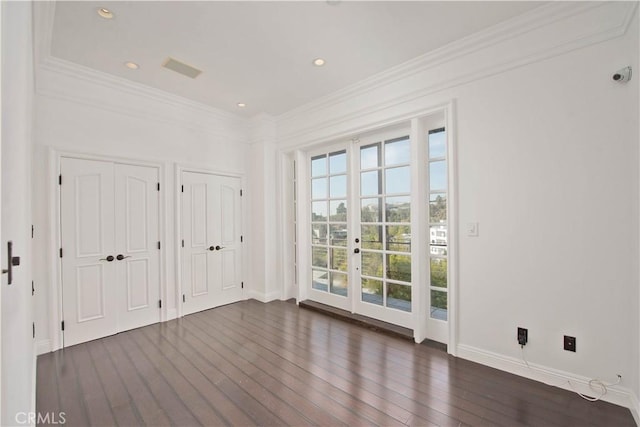 empty room with french doors, ornamental molding, and dark hardwood / wood-style floors