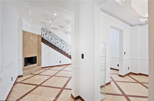 hallway featuring beamed ceiling, ornamental molding, and coffered ceiling