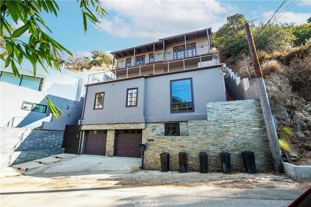 exterior space with a balcony and a garage