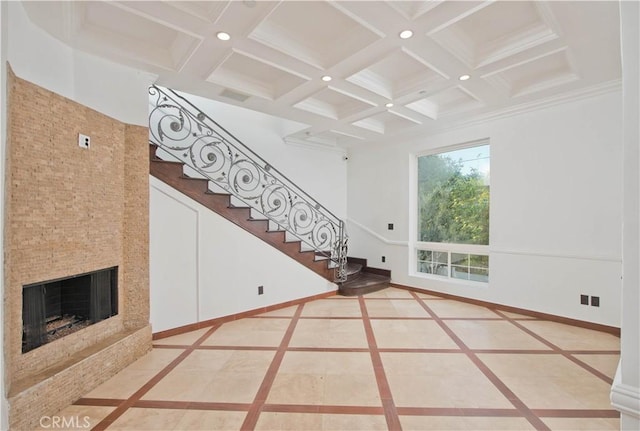 unfurnished living room featuring coffered ceiling, crown molding, and beamed ceiling