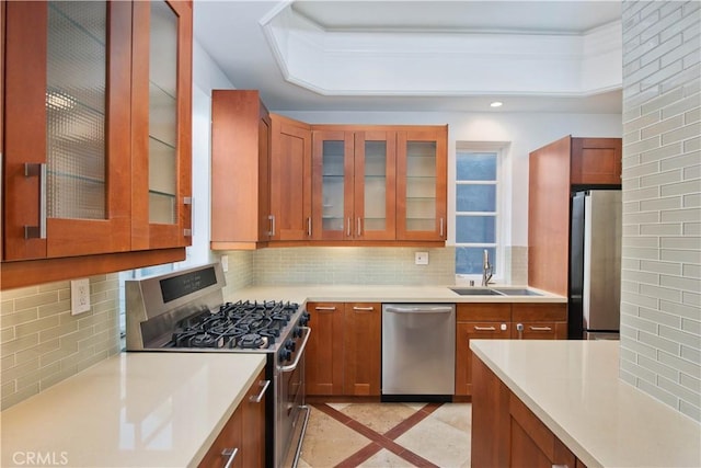 kitchen featuring stainless steel appliances, sink, and decorative backsplash