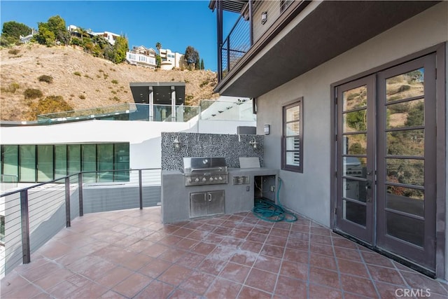 view of patio / terrace featuring french doors, an outdoor kitchen, and grilling area