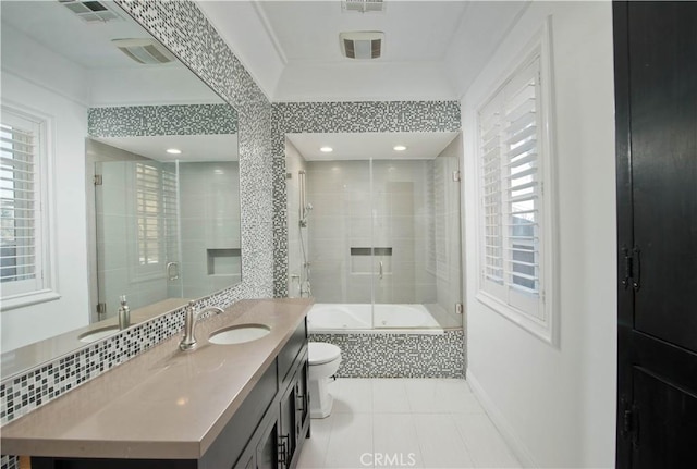 full bathroom with toilet, vanity, combined bath / shower with glass door, and tile patterned flooring