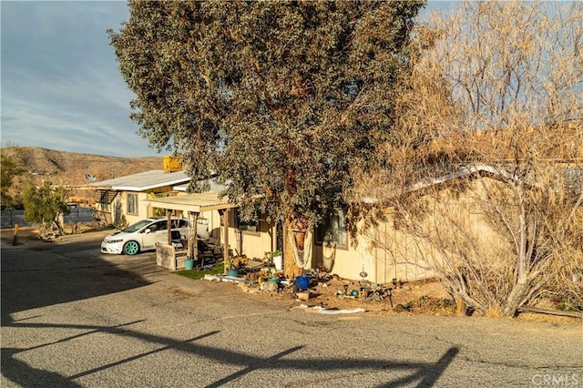 view of front of home with a mountain view and a carport