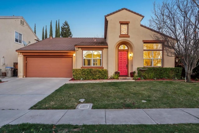 mediterranean / spanish-style house with a garage and a front yard