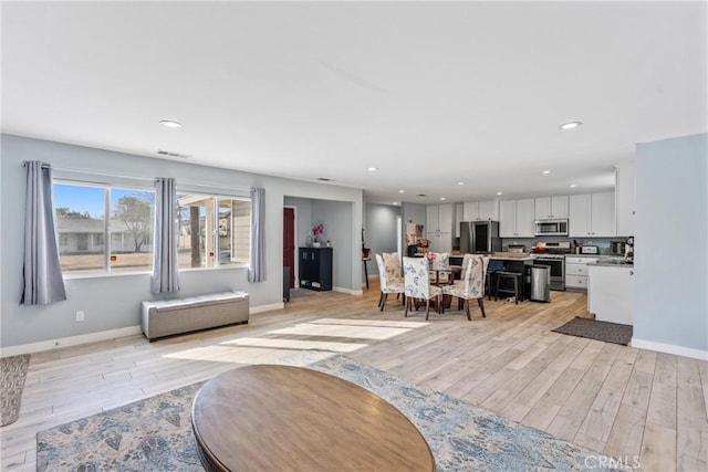 living room with light hardwood / wood-style flooring