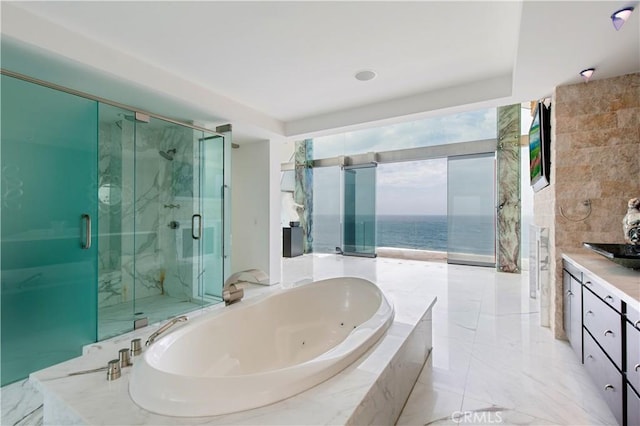 bathroom featuring vanity, plus walk in shower, and a water view