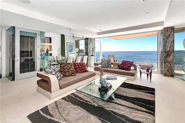 living room featuring floor to ceiling windows and a water view