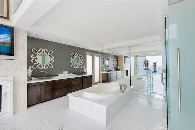 bathroom with vanity, shower with separate bathtub, and a raised ceiling