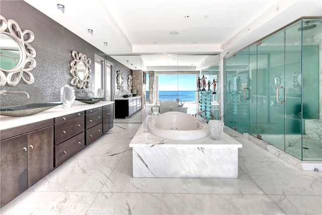 bathroom with vanity, plus walk in shower, and a water view