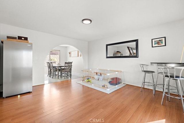 rec room with light hardwood / wood-style floors