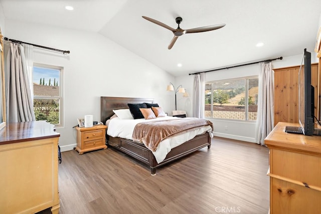 bedroom with hardwood / wood-style flooring, lofted ceiling, and ceiling fan