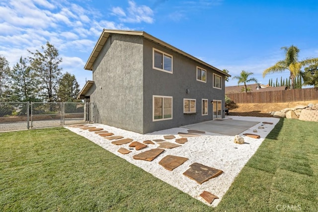 back of property featuring a yard and a patio area