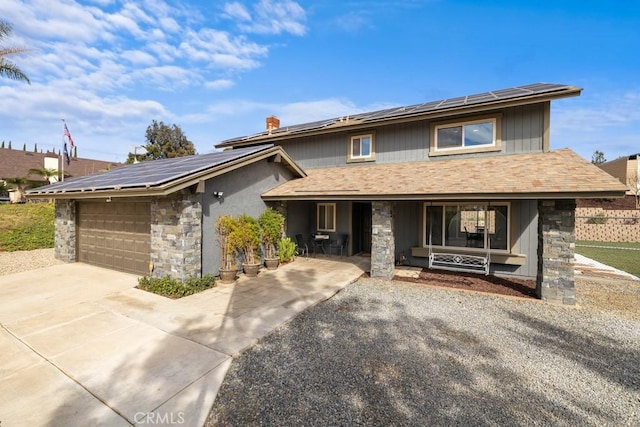 view of front of home featuring a garage and solar panels