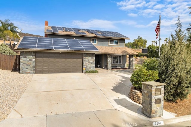 front of property featuring a garage and solar panels