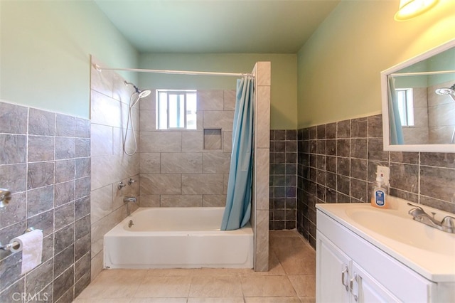 bathroom with shower / bath combo, tile walls, tile patterned floors, and vanity