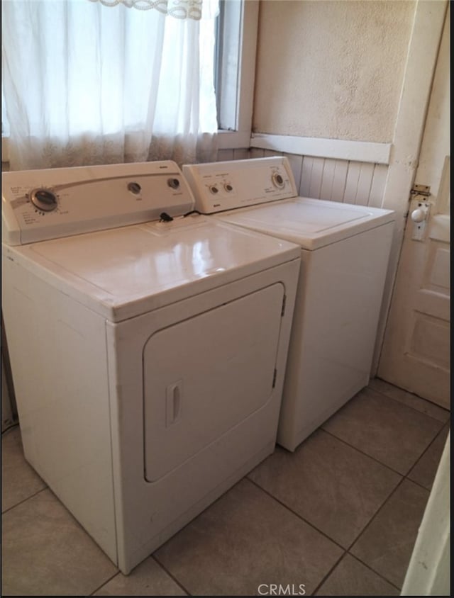 washroom featuring separate washer and dryer and light tile patterned floors