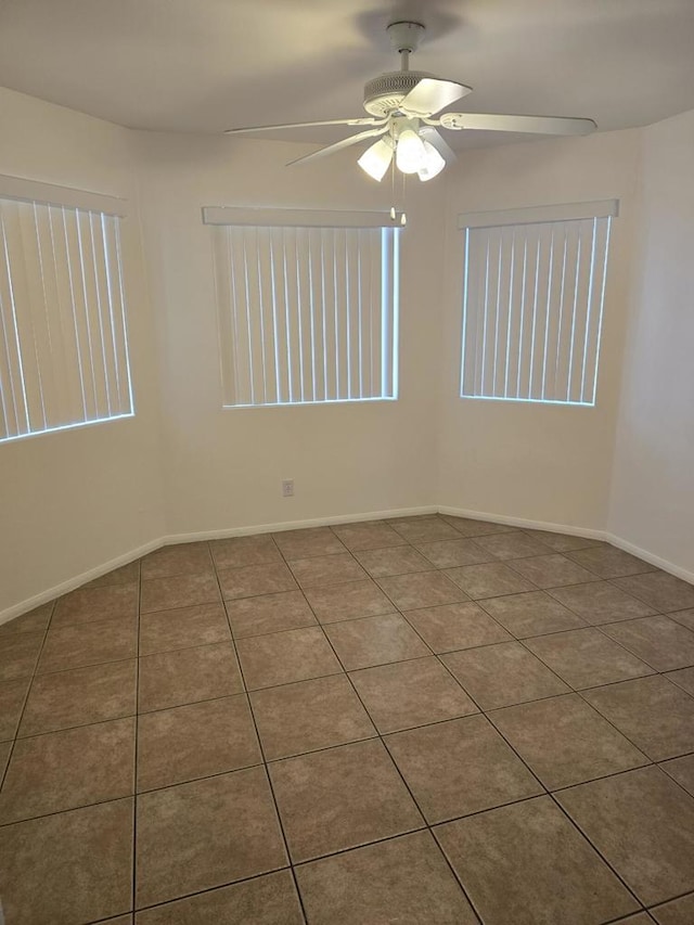 spare room featuring tile patterned flooring and ceiling fan