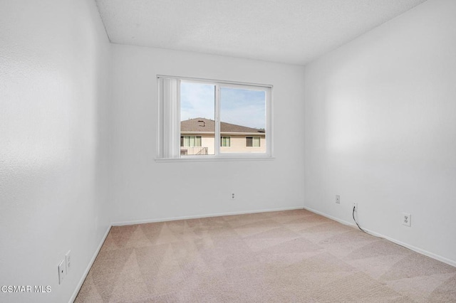 empty room featuring light colored carpet