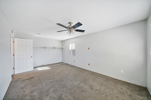 unfurnished bedroom with a ceiling fan, carpet, and a closet