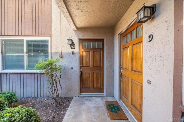 property entrance featuring stucco siding