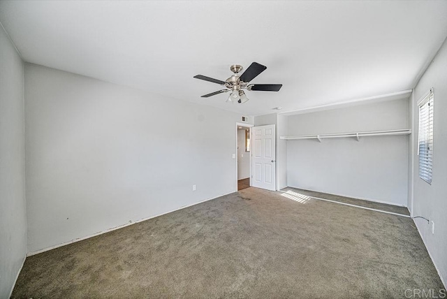 unfurnished bedroom featuring carpet floors, a closet, and a ceiling fan