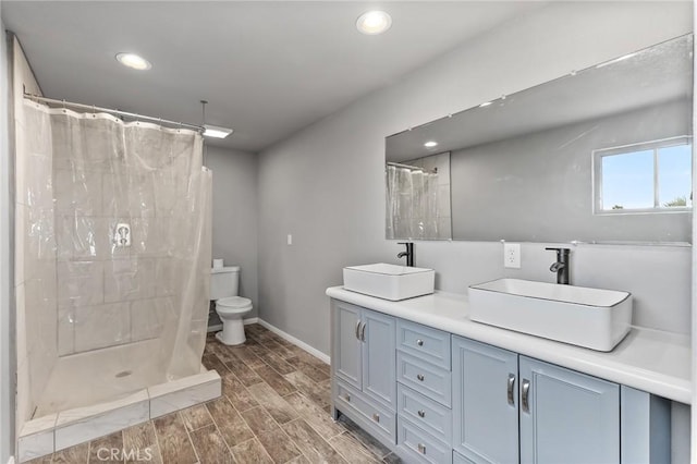 bathroom featuring vanity, toilet, and a shower with shower curtain