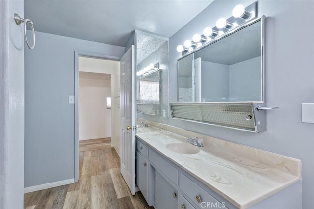 bathroom with hardwood / wood-style flooring and vanity