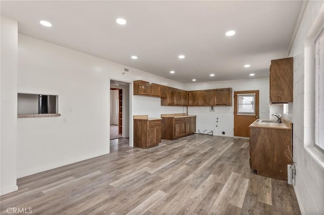 kitchen with sink and light hardwood / wood-style flooring