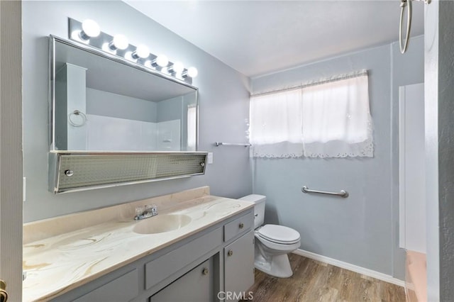 bathroom featuring vanity, hardwood / wood-style floors, toilet, and walk in shower