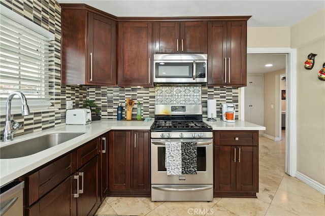 kitchen with tasteful backsplash, sink, and appliances with stainless steel finishes