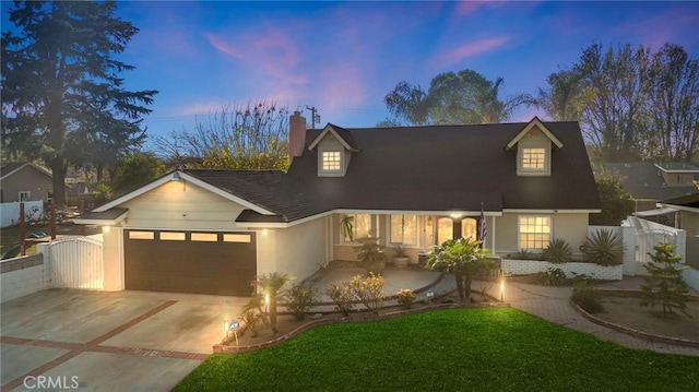 view of front of home with a garage and a lawn