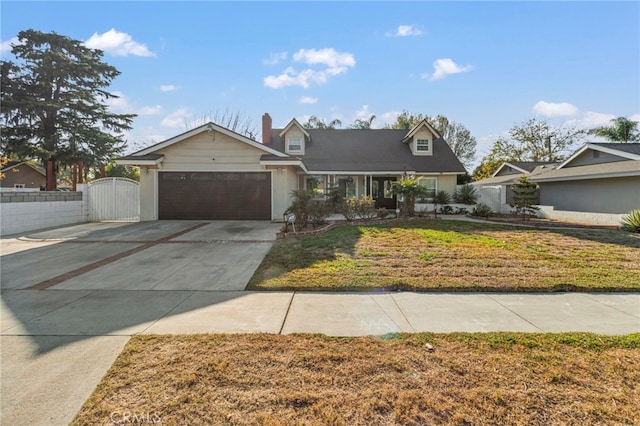 view of front of home featuring a garage and a front yard