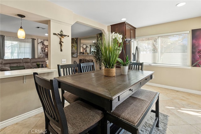 dining space featuring a healthy amount of sunlight and light tile patterned floors