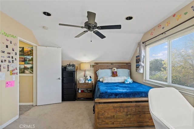 bedroom with ceiling fan, light colored carpet, and vaulted ceiling