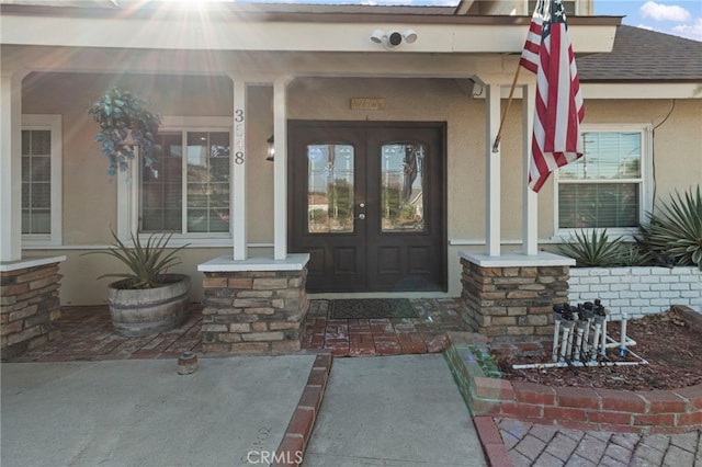 property entrance featuring french doors and covered porch