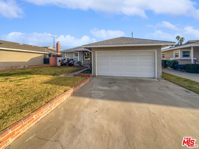 view of front of house with a garage and a front yard