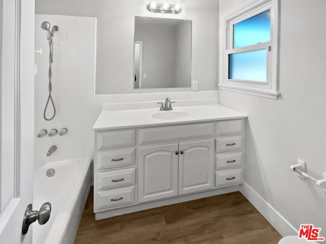 bathroom featuring vanity, hardwood / wood-style floors, and shower / bathing tub combination