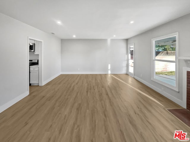 unfurnished living room with wood-type flooring