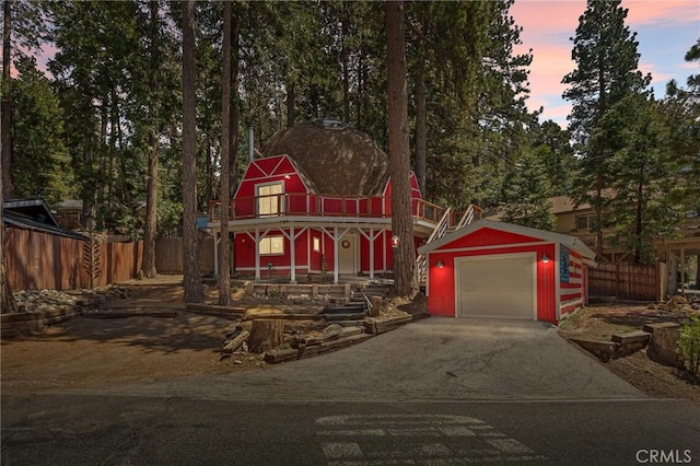 victorian home featuring a garage and an outdoor structure