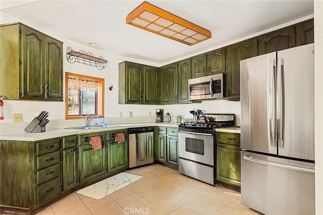 kitchen featuring sink, light tile patterned floors, and appliances with stainless steel finishes