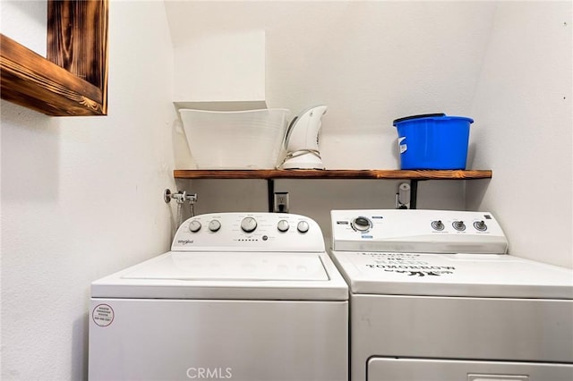 washroom with washing machine and dryer and cabinets