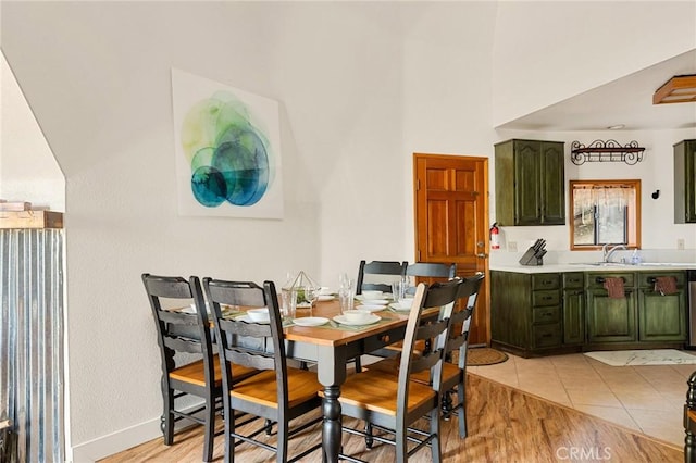 tiled dining room featuring sink