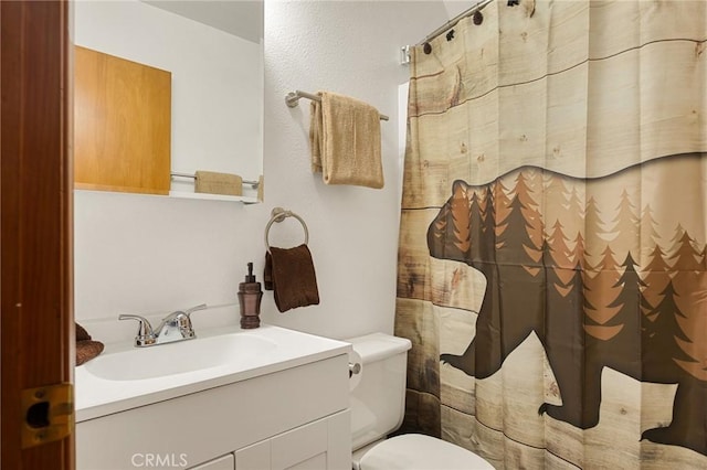 bathroom featuring vanity and toilet