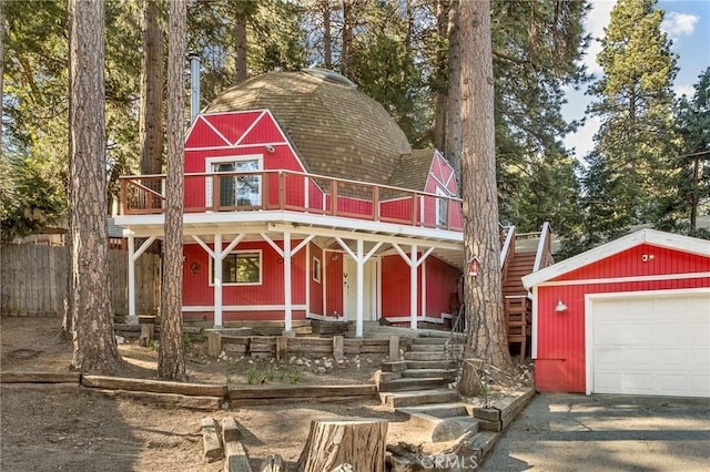 view of front of property featuring a garage and an outdoor structure