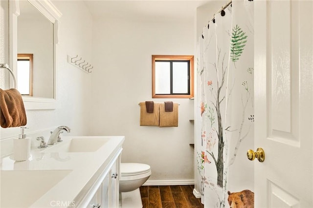 bathroom featuring vanity, curtained shower, and toilet