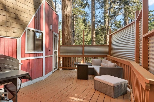 wooden terrace with an outdoor living space